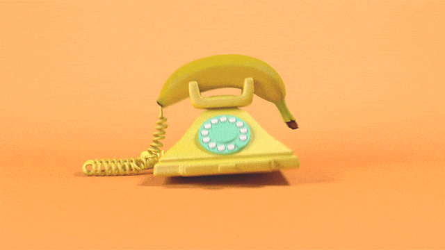 GIF con un telefono giallo vintage scalpitante con la cornetta a forma di banana